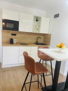 a kitchen with a table and chairs and a bowl of fruit at Villa Tajnikov in Hvar +11 photos