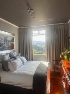a bedroom with a bed and a large window at Miguels Seaview Corner in Ponta do Sol +58 photos