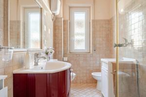 a bathroom with a sink and a toilet at 2 Suite a due passi dal Mare, Wi-Fi e Natura in Pescara +8 photos