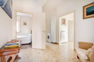 a living room with a couch and a bedroom at 2 Suite a due passi dal Mare, Wi-Fi e Natura in Pescara