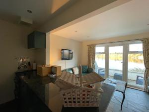 a living room with a wicker chair and a couch at Lochside Apartment in Moffat