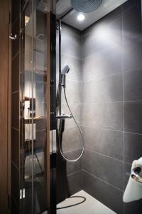 a shower with a glass door in a bathroom at KIORI Hotel Takakura in Kyoto