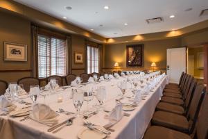 een vergaderzaal met een lange tafel met glazen en servetten bij The Glen Club in Glenview