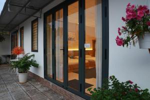 a glass door of a house with a bedroom at gold star homestay in Long Hai