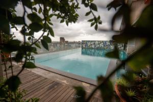a large swimming pool on top of a building at Hotel Vrishali Executive in Kolhapur