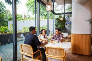 a group of people sitting at a table in a restaurant at ARTOTEL Casa Kuningan in Jakarta +17 photos