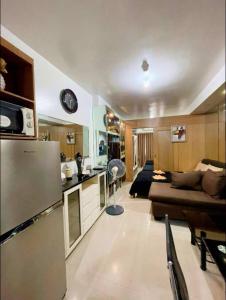 a kitchen and living room with a couch and a refrigerator at Shell Residence Tower A 250A in Manila