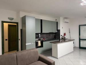 a kitchen with a couch and a counter in a room at Borgata Lu Fraili in Nuragheddu