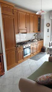 a kitchen with wooden cabinets and a stove at Ca da Simo in Albenga