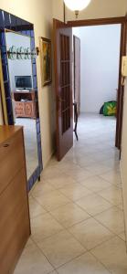 a hallway with a door and a tile floor at Ca da Simo in Albenga +1 photo