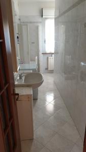 a white bathroom with a sink and a shower at Ca da Simo in Albenga