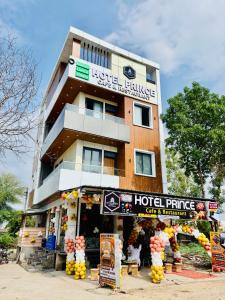 a hotel building with a hotel price sign in front of it at Hotel Prince Cafe & Restaurant in Shāhpura