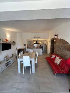 a living room with a red couch and a table at B&B li salcuneddi in Aglientu