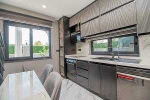 a kitchen with a sink and a table at Villa Lolivia in Belek