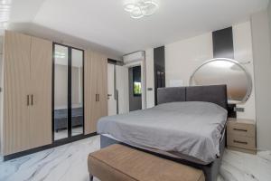 a bedroom with a bed and a mirror on the wall at Villa Lolivia in Belek +17 photos