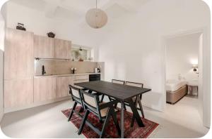 a dining room with a table and chairs and a kitchen at Niva 2- stunning sea view 2 bedroom apartment in Dubrovnik