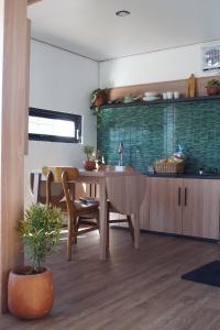 a kitchen with a table and a dining room at Ullasa Villa Dieng in Diyeng +17 photos