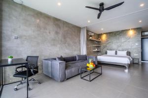 a living room with a couch and a bed at Brand new apartment with stunning sunset views in Munggu