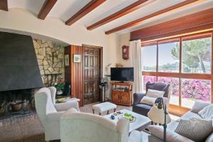 a living room with a couch and a fireplace at Winahost Calonge Avenida Països Catalans in Calonge