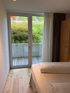 a bedroom with two beds and a sliding glass door at Apart Zwieselblick in Sölden
