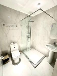a bathroom with a shower and a toilet and a sink at North Star Hotel in Yakkasaray