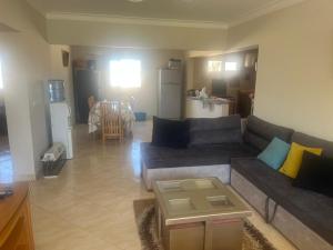 a living room with a couch and a table at داون تاون مارينا in El Alamein