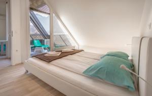 a large bed in a room with a large window at Apartments Eurolux - Bohinjska Bistrica in Bohinj