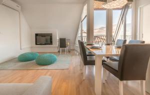 a dining room with a table and chairs and a television at Apartments Eurolux - Bohinjska Bistrica in Bohinj