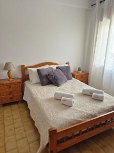 a bedroom with a large bed with two pillows at Costa Mar by Albufeira Rental in Olhos de Água