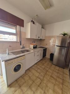 a kitchen with a sink and a washing machine at Costa Mar by Albufeira Rental in Olhos de Água
