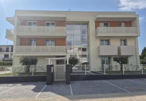 a building with a parking lot in front of it at Fly Residence Venice in Venice