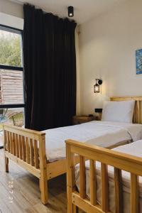 a bedroom with two beds and a window at Arevaham Boutique Hotel in Stepʼanavan +140 photos