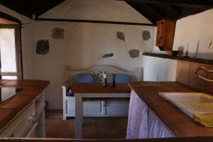 eine Küche mit Tisch und Arbeitsplatte in der Unterkunft El Cortijo in Garafía + 30 Fotos