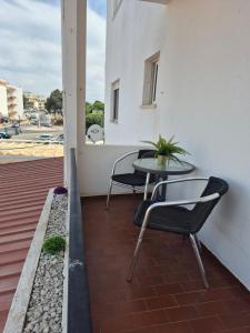 a patio with a table and chairs on a balcony at Costa Mar by Albufeira Rental in Olhos de Água +2 photos