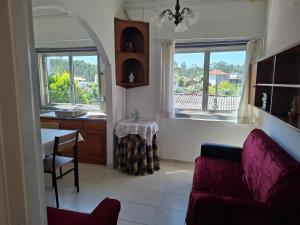 a living room with a couch and a table and windows at Casa do Vale in Arrabal +20 photos