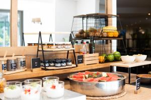 a table with a bowl of watermelon on a counter at Arenas Atiram Hotel in Barcelona