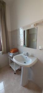 a white bathroom with a sink and a mirror at B&B Le Ginestre in Foria +29 photos