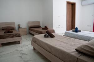 a room with three beds in a room at Your Gzira Base Near Nightlife in Il-Gżira
