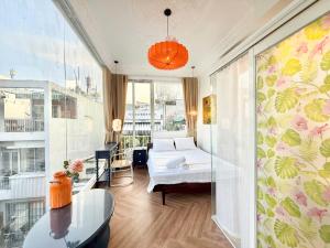 a bedroom with a bed and a table in a room at Cherry Blossom Boutique Hotel Entire House Bui Vien in Ho Chi Minh City +26 photos