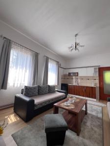 a living room with a couch and a table at Apartmani Odmor Fojnica in Fojnica