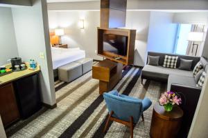 a living room with a couch and a tv at Crowne Plaza Dulles Airport, an IHG Hotel in Herndon