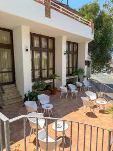 a patio with chairs and tables on a building at Hotel Residence Eden in Palinuro +31 photos