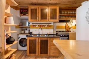 a kitchen with wooden cabinets and a sink at GuestReady - Exceptional house near Colares in Colares +92 photos