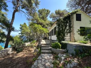 a house with stairs leading up to a house at House Neli in Srednje Selo na Šolti