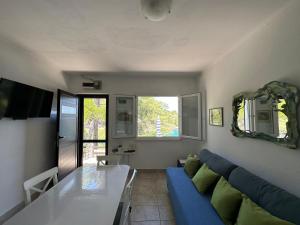 a living room with a blue couch and a table at House Neli in Srednje Selo na Šolti