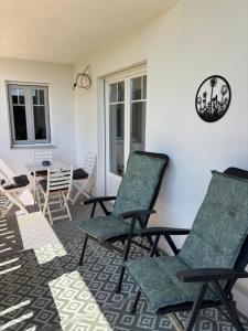 a room with two chairs and a table and a table at Domizil NinaSol in Wallendorf