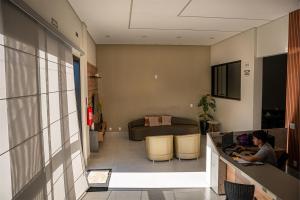 a person sitting at a counter in a room at Norte Hotel in Taiobeiras