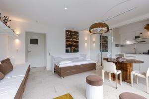 a living room with a bed and a table at Huswell Studio 14 in Knokke-Heist +24 photos