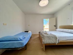 a room with two beds and a chair in it at Villa with Pool, Chill-Out & BBQ in Torrevieja +63 photos