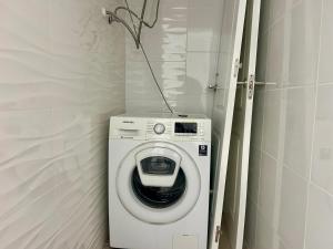 a washing machine in a corner of a room at Villa with Pool, Chill-Out & BBQ in Torrevieja